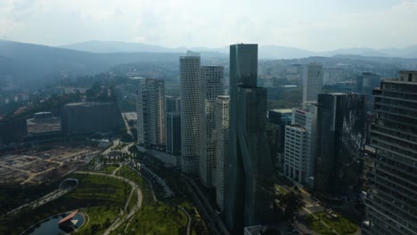 modern skyscrapers in mexico city's santa fe district, sierra madre mountains
