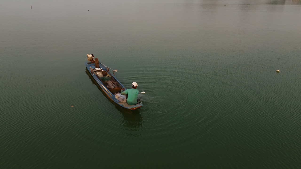 Fisherman fishing in a small boat on a lake