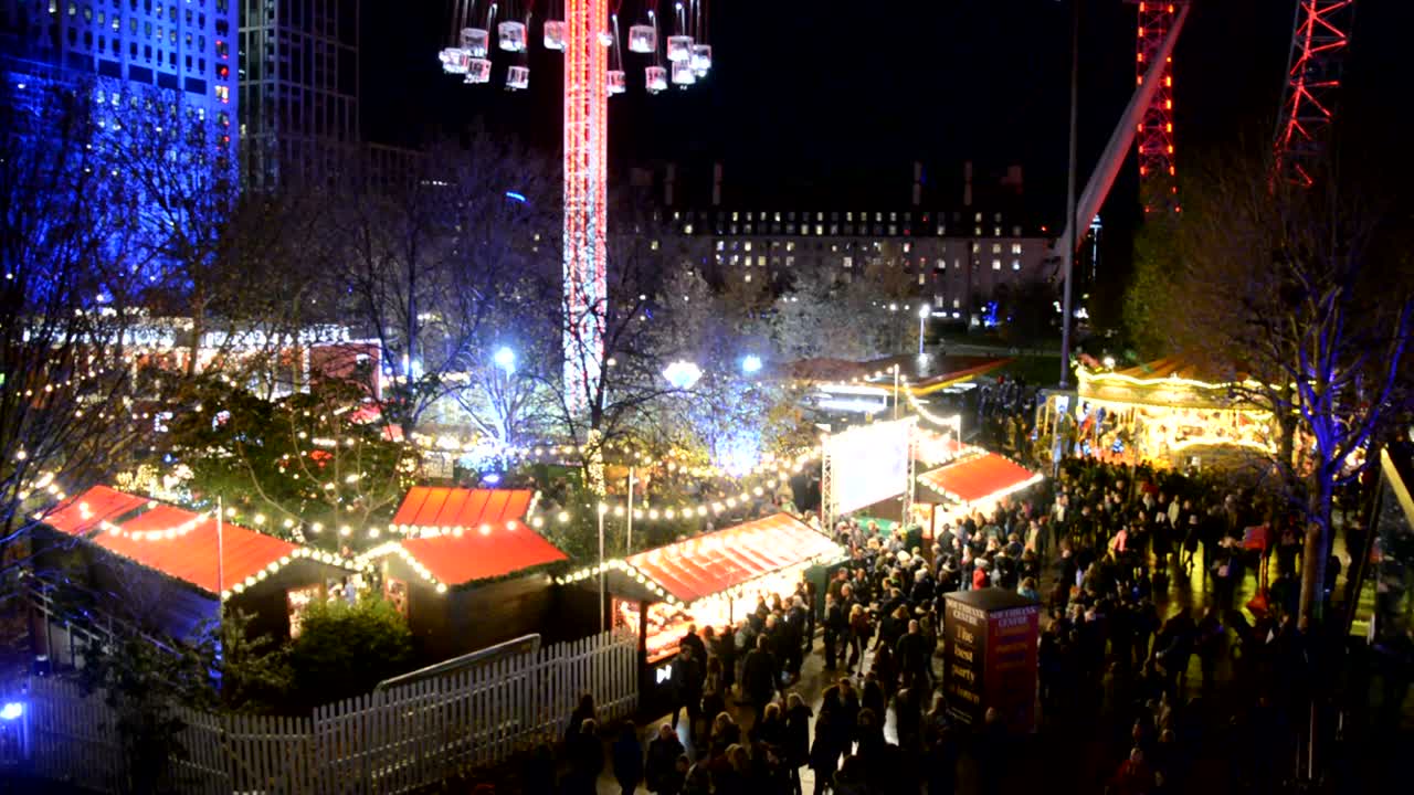 Busy Christmas Market near London Eye at night with the main attractions