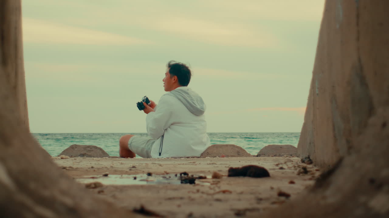 Man taking photos at the beach