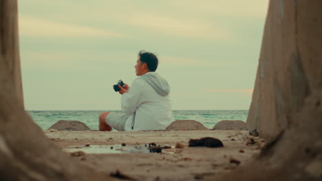 man taking photos at the beach