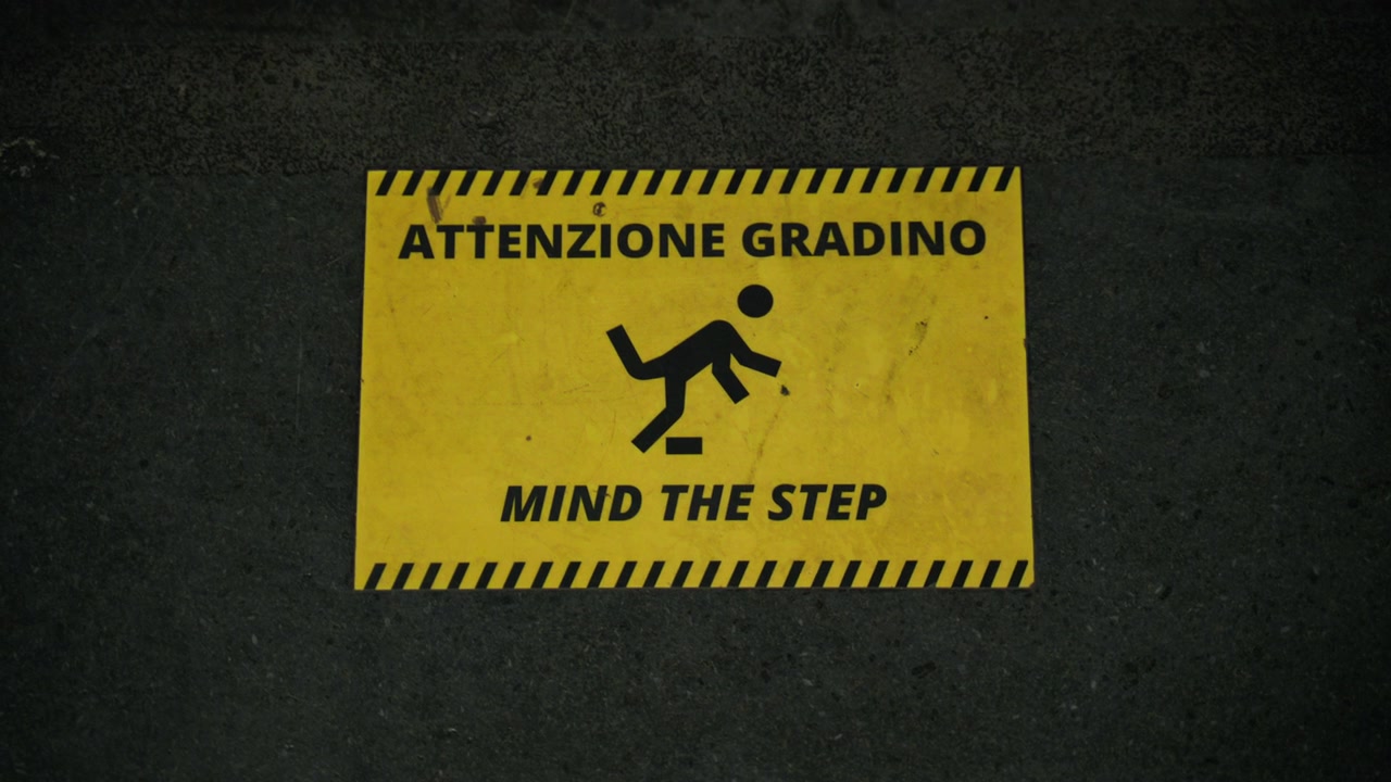Mind the step warning sign at the Naples metro station