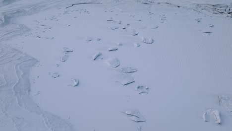 aerial view over iceberg in skaftafellsjokull glacier covered in snow, iceland