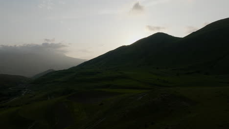 fly over sloping mountains during sunset near chobareti in samtskhe-javakheti province of georgia
