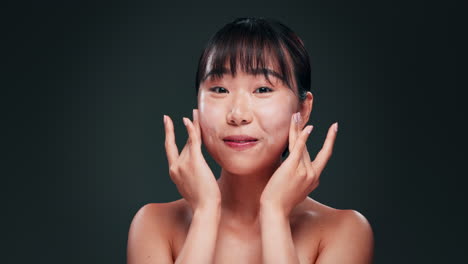 woman applying facial cream