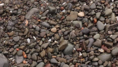 Stones-on-the-beach-are-moved-by-waves-on-shore