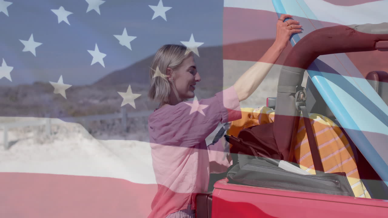 Animation of flag of usa over caucasian woman by beach