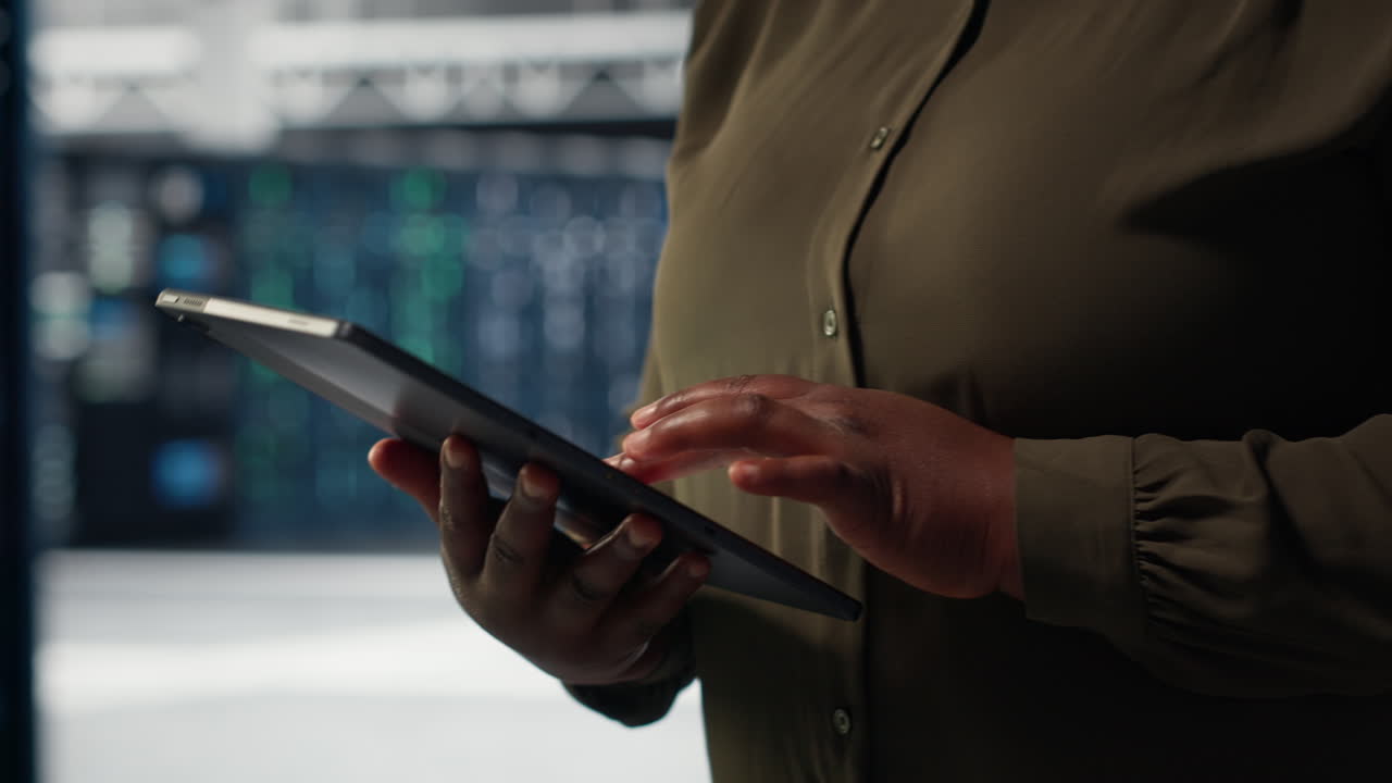 Engineer at work using green screen laptop in data center to check hardware