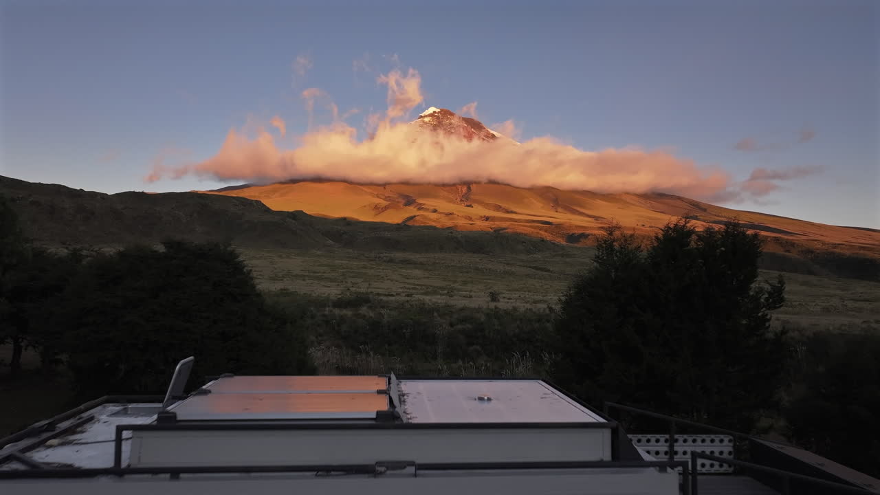 Aerial Shot Expedition Truck Campsite at Cotopaxi National Park Ecuador, sunset volcano golden hour