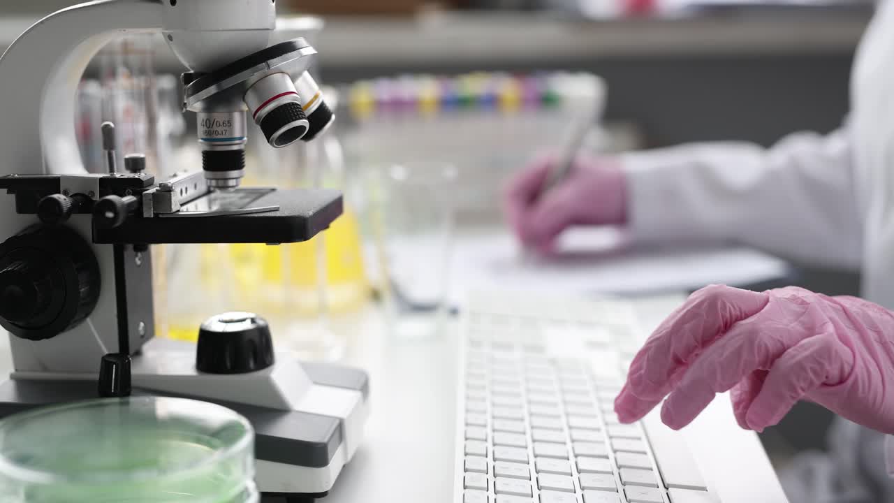 Scientist working in laboratory with microscope