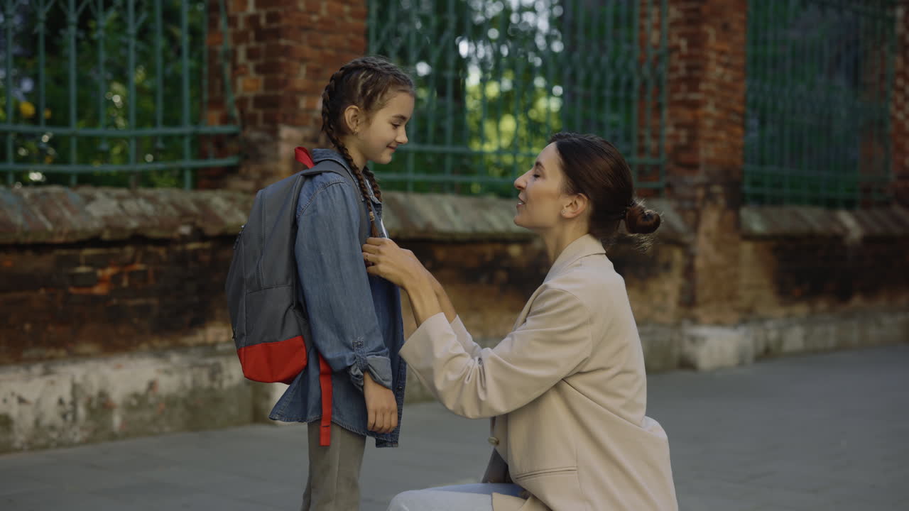 Mother and Daughter at School Entrance