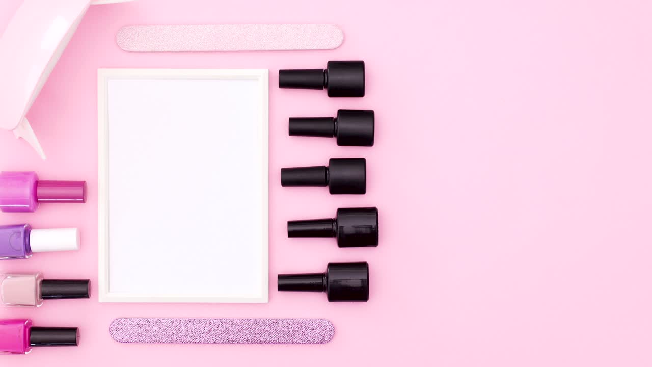 Manicure tools and nail polish bottles with frame for text on pink theme. Stop motion