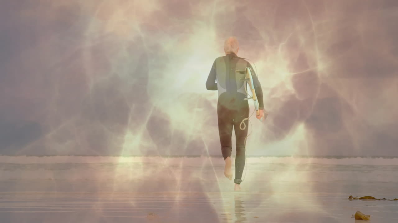 Senior surfer walking into water on beach with surfboard, featuring animated bokeh for health