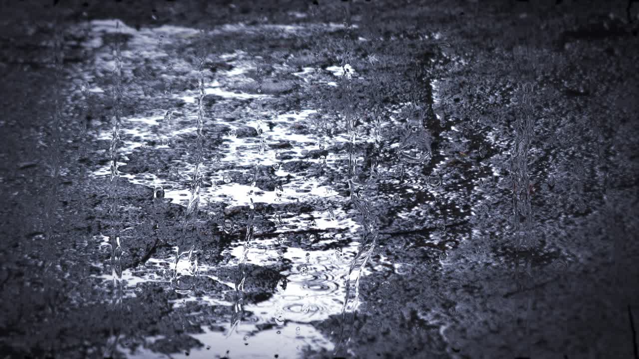 Heavy rain shower downpour cloudburst rainfall behind the glass.