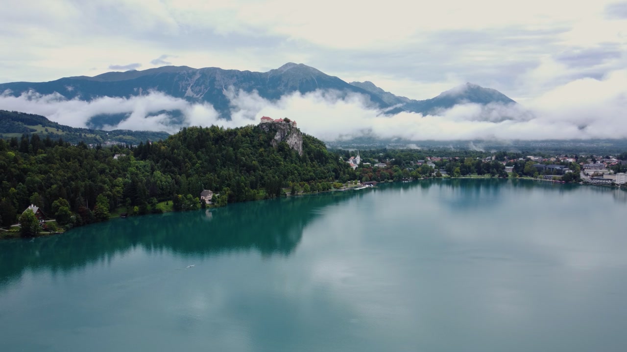 AERIAL Breathtaking Orbiting Shot of Lake Bled, Slovenia on a Cloudy Day