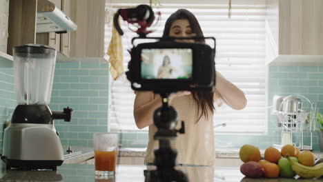 a young woman recording herself in the kitchen