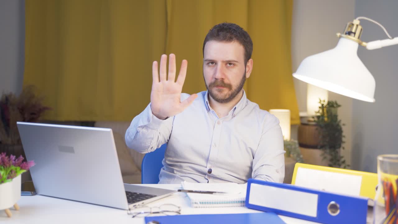 trabajador de oficina en casa hombre dice parar a la cámara, advierte.