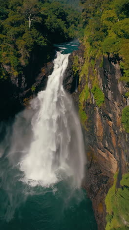 powerful waterfall cascading down rocky cliffs