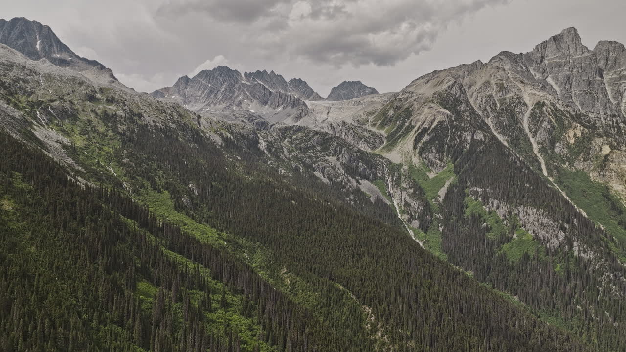 Rogers Pass BC Canada Aerial v2 drone flyover Glacier National Park capturing dramatic mountain scenery, with towering peaks, steep cliffs, and dense forests - Shot with Mavic 3 Pro Cine - July 2023