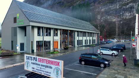 aerial rises over protest car from norges miljovernforbund near municipality house in modalen, norway, advocating geothermal energy over wind turbines