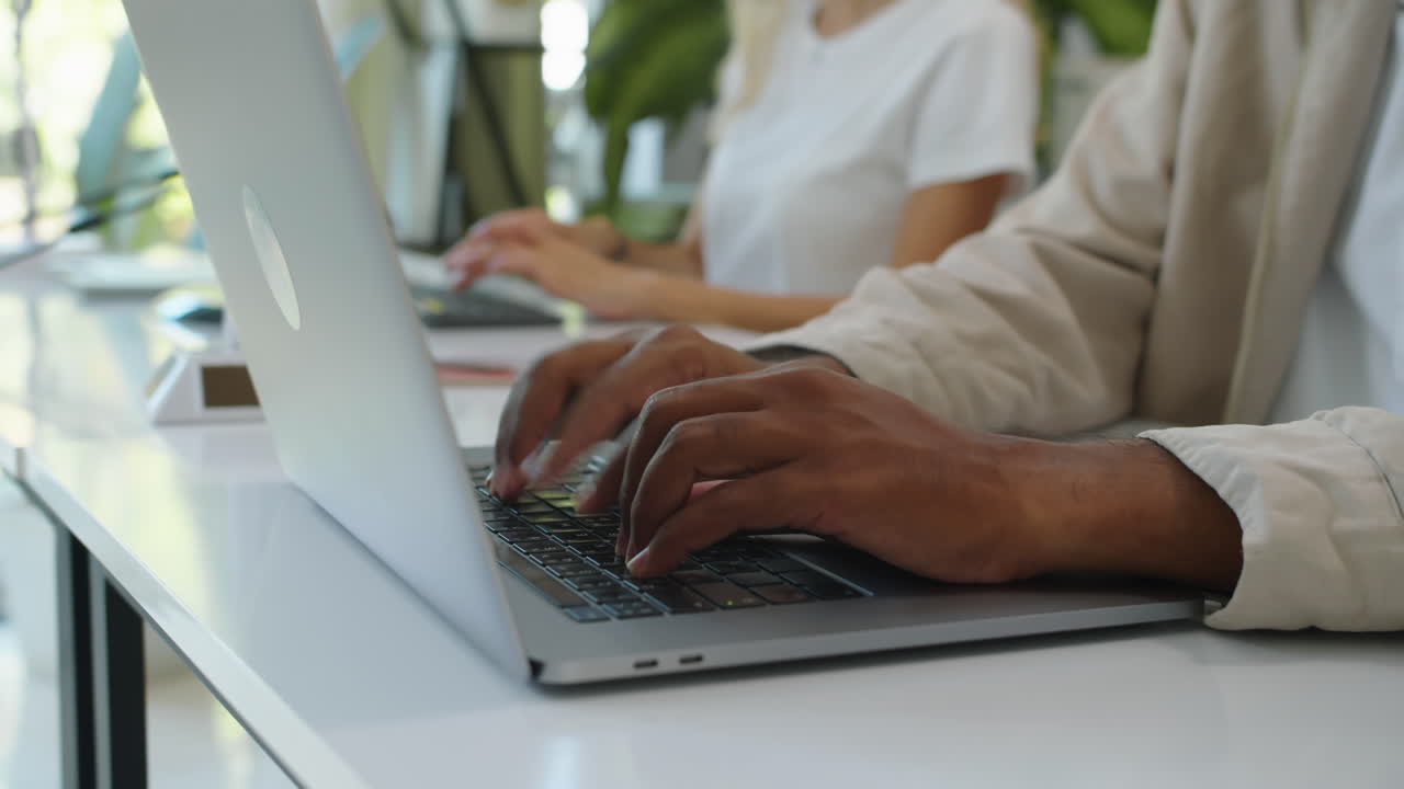 Hands of Managers Working on Computers at Office Table
