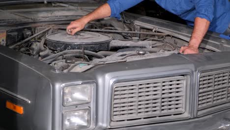 a person working on a car engine