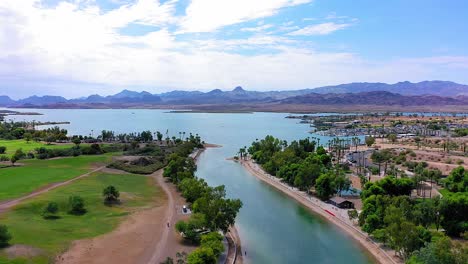 Flying-backwards-over-the-London-Bridge-in-Lake-Havasu-City,-Arizona-looking-at-the-canal