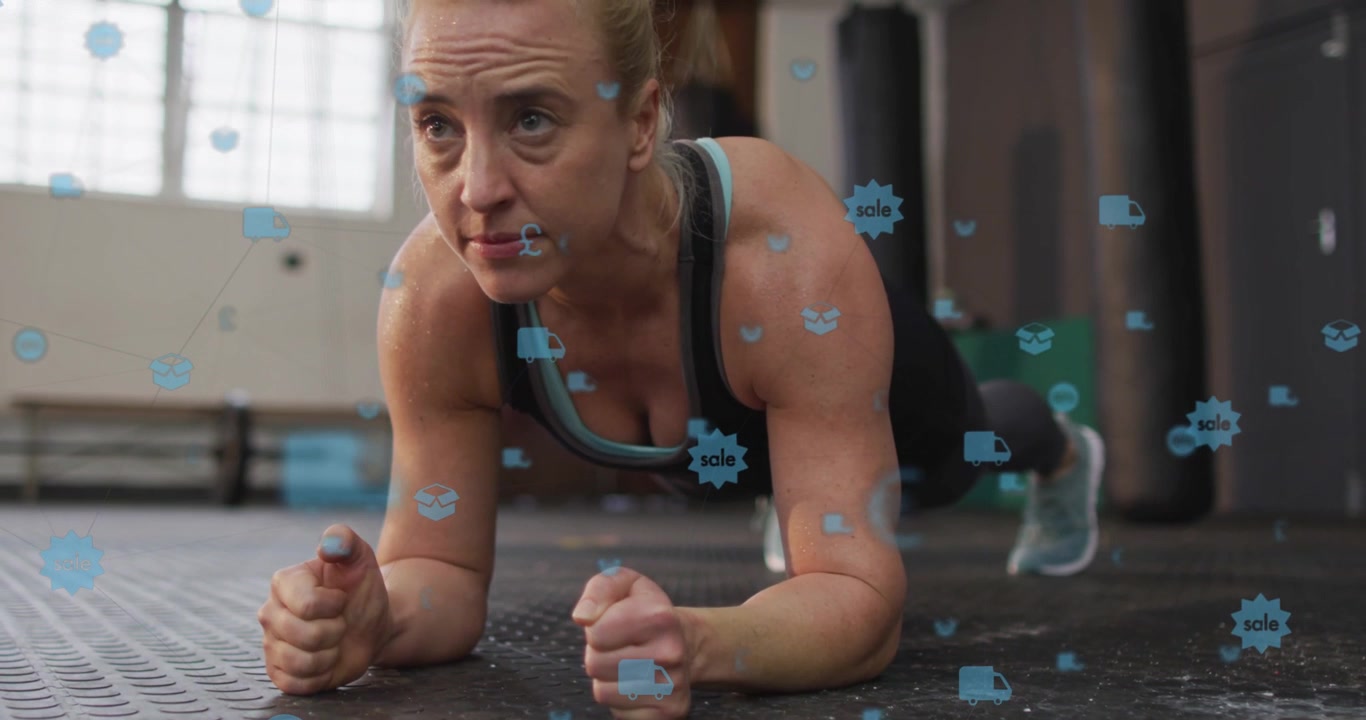 Woman planting forearms and holding plank on gym floor for fitness, blue icons highlighting form