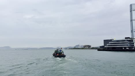 footage captured from a ferry in hong kong, showcasing the city skyline, bustling harbor, moving vessels, and waterfront activity, highlighting the dynamic energy and scenic beauty of victoria harbour