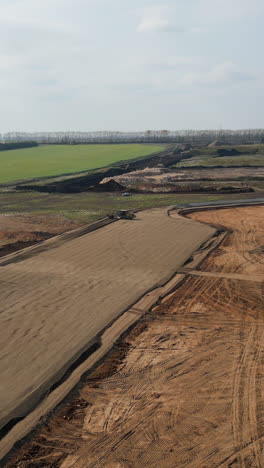 aerial view of construction site with earthwork and machinery