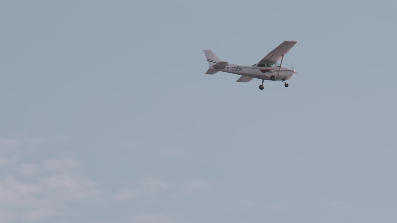 Small aircraft flying in the cloudy sky
