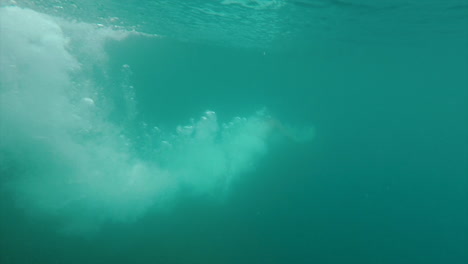 man jumps from cliff into lake