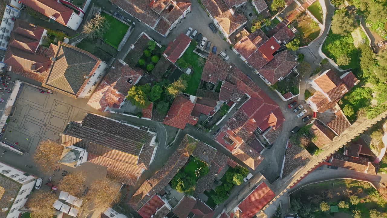Aerial view european village with red buildings roofs sunny evening. Cozy houses