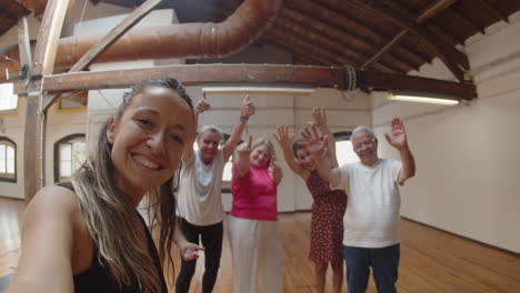 profesor de baile tomando selfie con personas mayores después de la clase de baile