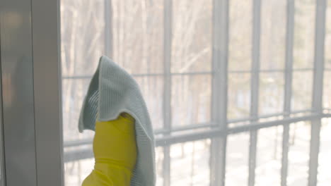 Close-Up-View-Of-Cleaning-Man-Hands-With-Gloves-Cleaning-The-Window-Panes-With-A-Rag-And-Glass-Cleaner-Inside-An-Office