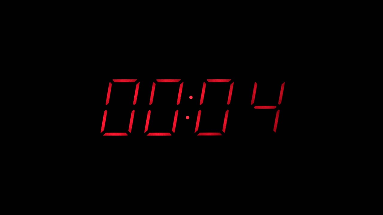 Red digital clock countdown to zero slow zoom in