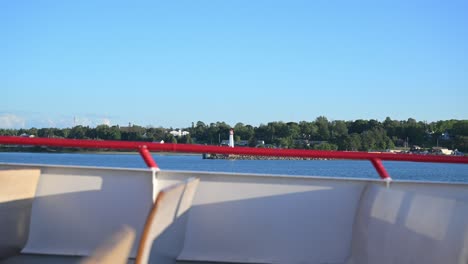 view of the small decorative lighthouse from a ferry leaving st