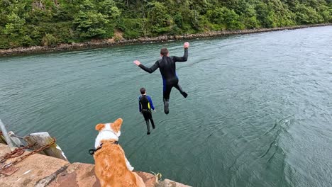 two friends jump into the sea