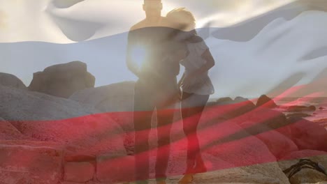 animation of flag of russia over african american couple at beach