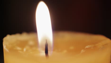 macro shot of a candle being lit with a lighter