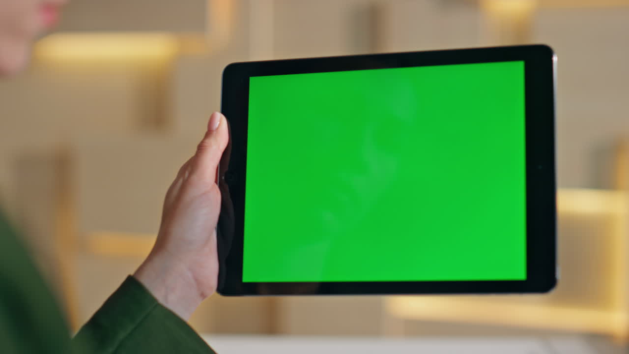 Manager hand hold chromakey tablet watching social media at workplace close up.