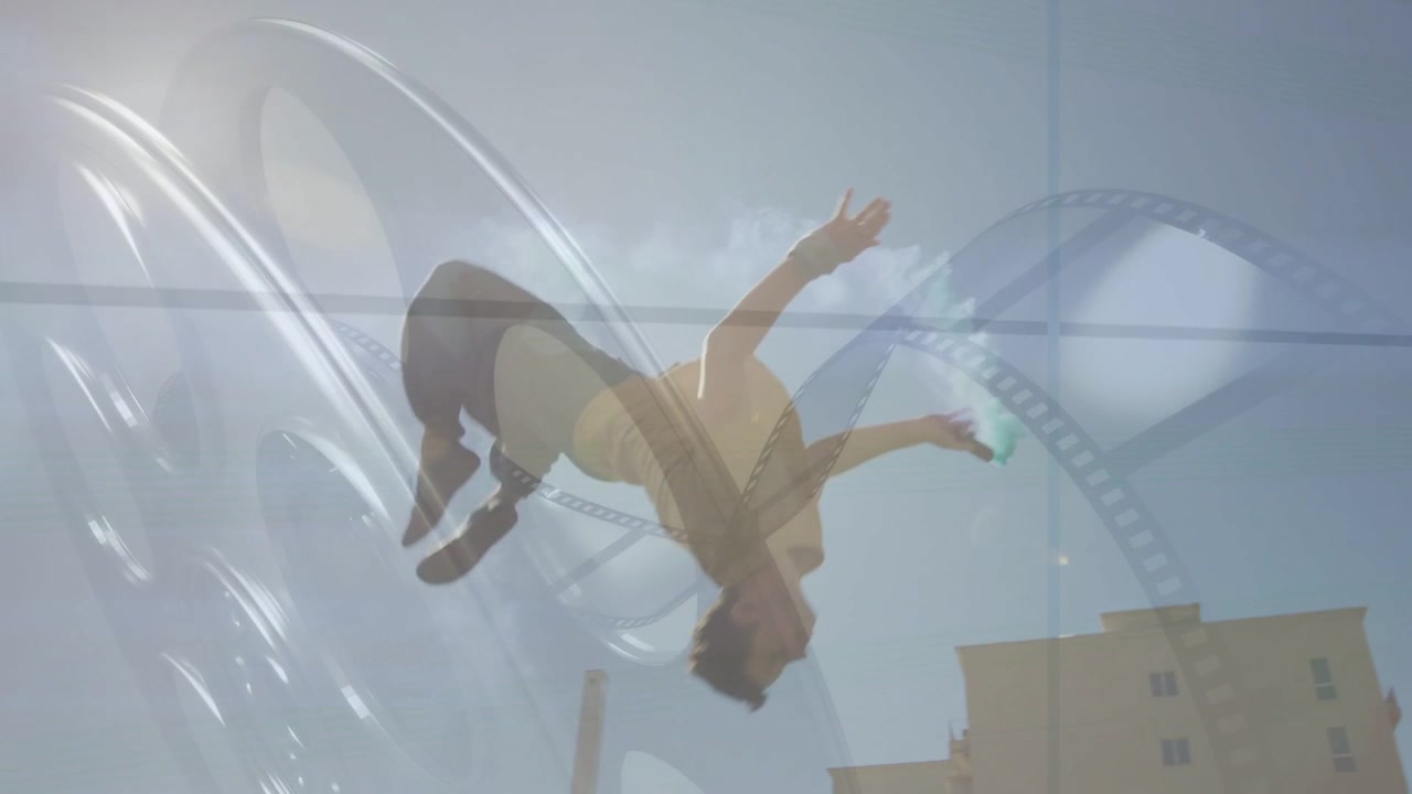 Parkour trainee pausing on roof, launching backflip, trailing teal smoke, landing on mat, film arcs