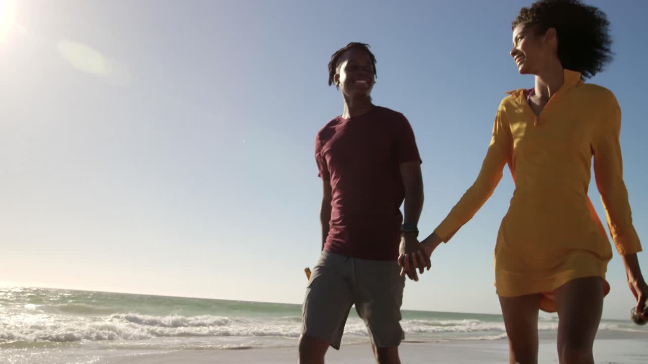 Couple walking together on the beach 4k