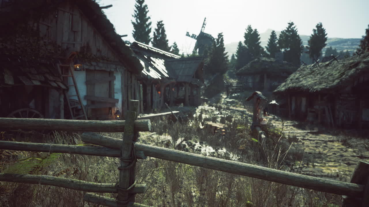 Rustic village landscape with wooden houses and windmill at dawn