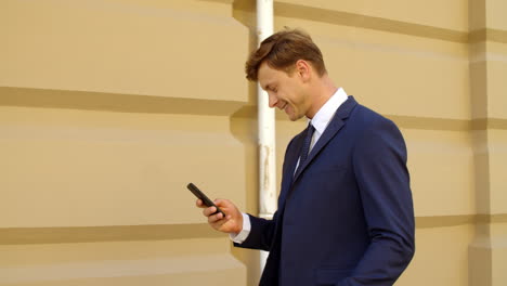 happy business man celebrating success outdoors. excited businessman