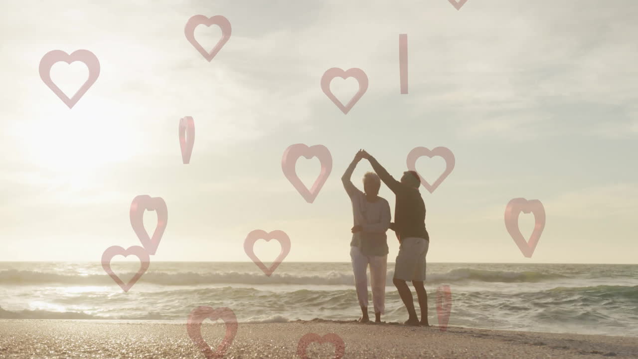 Dancing on beach, couple surrounded by heart shapes animation overlay