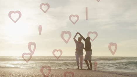 dancing on beach, couple surrounded by heart shapes animation overlay