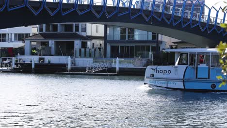 a ferry travels under a bridge