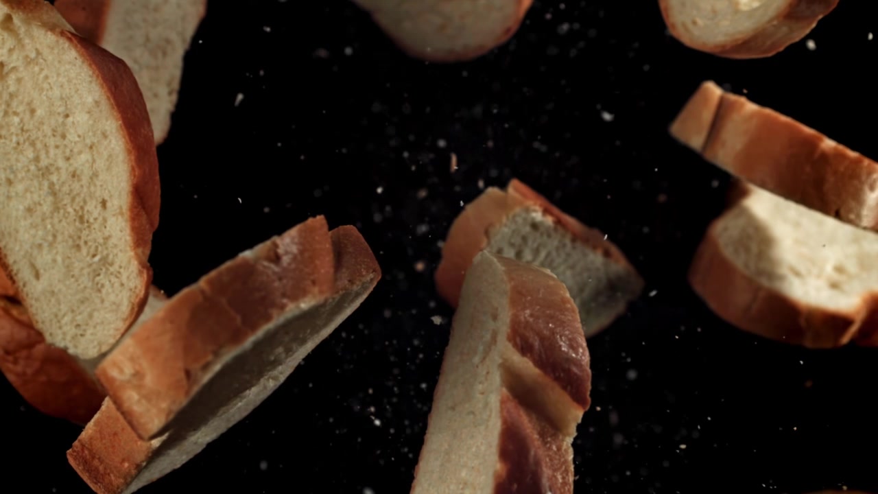 Slices of Fresh Bread Floating in Slow Motion on Black Background