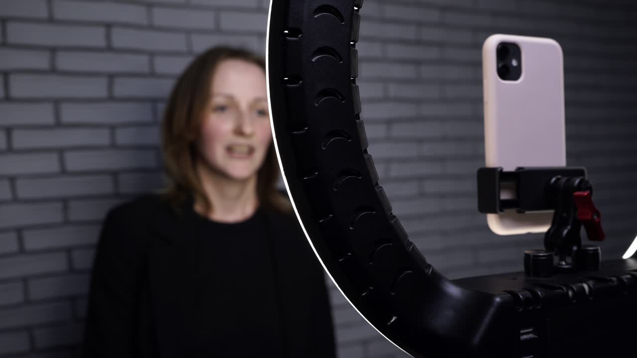 Footage of blogger woman shooting story with smartphone